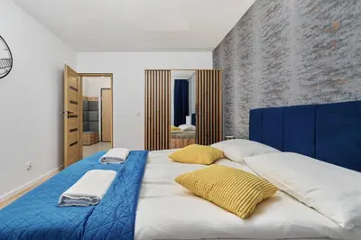 Łóżko lub łóżka w pokoju w obiekcie Nowa Manufaktura Apartment Wrocław Krzyki by Noclegi Renters