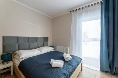 Łóżko lub łóżka w pokoju w obiekcie Apartament Słoneczny z tarasem i ogrodem