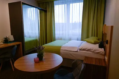 Łóżko lub łóżka w pokoju w obiekcie Zielone Apartamenty z aneksem kuchennym