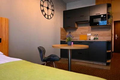 Łóżko lub łóżka w pokoju w obiekcie Zielone Apartamenty z aneksem kuchennym