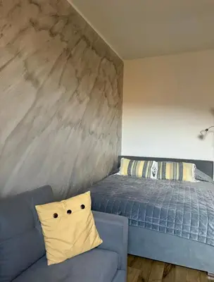 Łóżko lub łóżka w pokoju w obiekcie Dawna Mleczarnia Apartamenty SŁONECZNY