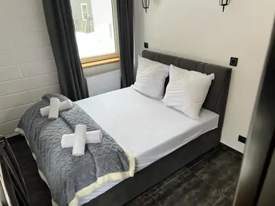 Łóżko lub łóżka w pokoju w obiekcie Apartamenty Slowianka