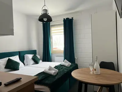 Łóżko lub łóżka w pokoju w obiekcie Apartamenty Slowianka -Studio