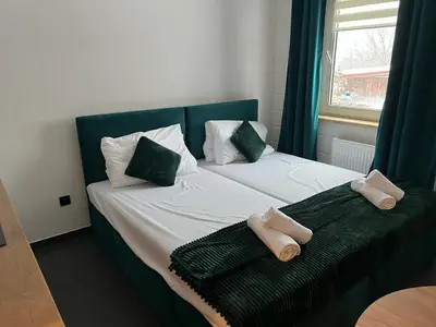 Łóżko lub łóżka w pokoju w obiekcie Apartamenty Slowianka -Studio