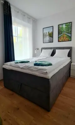 Łóżko lub łóżka w pokoju w obiekcie Apartamenty Dębowa 3
