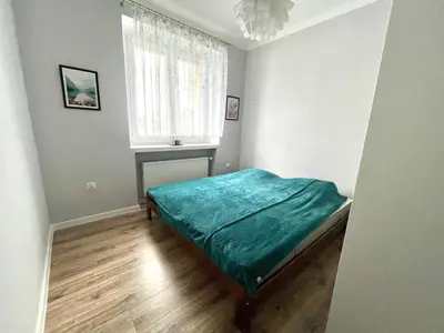 Łóżko lub łóżka w pokoju w obiekcie Apartament Jaskółka