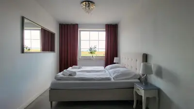 Łóżko lub łóżka w pokoju w obiekcie Apartamenty Czerwona Stodoła