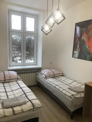 Łóżko lub łóżka w pokoju w obiekcie Apartament Rodzinny L7