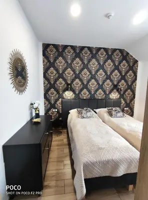 Łóżko lub łóżka w pokoju w obiekcie Apartamenty Pod Lipami