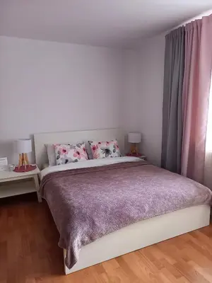Łóżko lub łóżka w pokoju w obiekcie Apartamenty AGAT