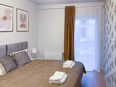 Łóżko lub łóżka w pokoju w obiekcie Apartament Cudovny z własnym ogródkiem i miejscem parkingowym w garażu