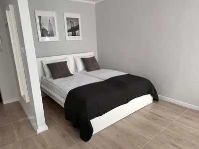 Łóżko lub łóżka w pokoju w obiekcie APARTAMENT OŚ. ZŁOTE 5F