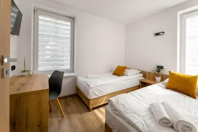 Łóżko lub łóżka w pokoju w obiekcie Apartament Centrum B