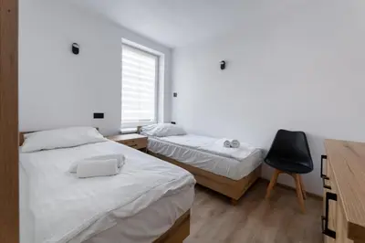Łóżko lub łóżka w pokoju w obiekcie Apartament Centrum A