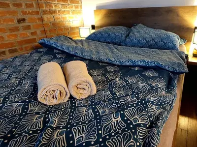 Łóżko lub łóżka w pokoju w obiekcie Apartament loftowy