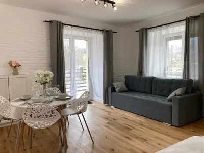 Część wypoczynkowa w obiekcie nowy Rustykalny apartament z tarasem - Willa Sowia
