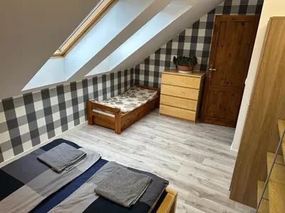 Łóżko lub łóżka w pokoju w obiekcie Willa Bukówka Dom całoroczny w górach nad jeziorem z jacuzzi i sauną