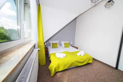 Łóżko lub łóżka w pokoju w obiekcie Rezydencja Klonowa