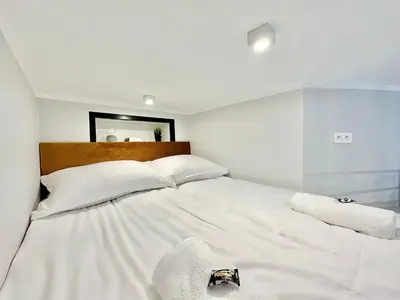 Łóżko lub łóżka w pokoju w obiekcie Loft Apartments Gliwice