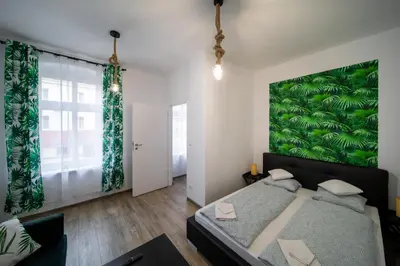 Łóżko lub łóżka w pokoju w obiekcie Jungle Vision Apartment - Rynek