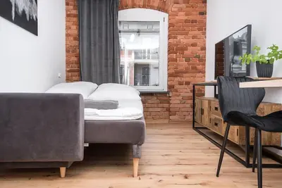 Łóżko lub łóżka w pokoju w obiekcie Apartament Zwycięstwa